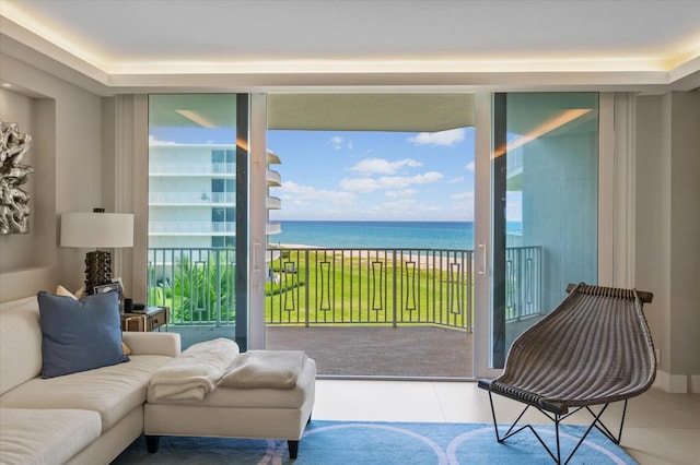 interior space with expansive windows, tile patterned flooring, and a water view