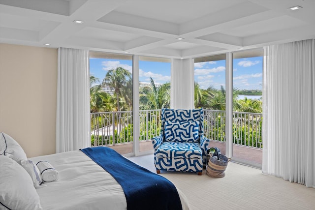 carpeted bedroom featuring expansive windows, coffered ceiling, and access to exterior