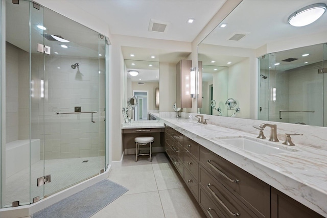 bathroom with double vanity, a stall shower, visible vents, tile patterned floors, and a sink