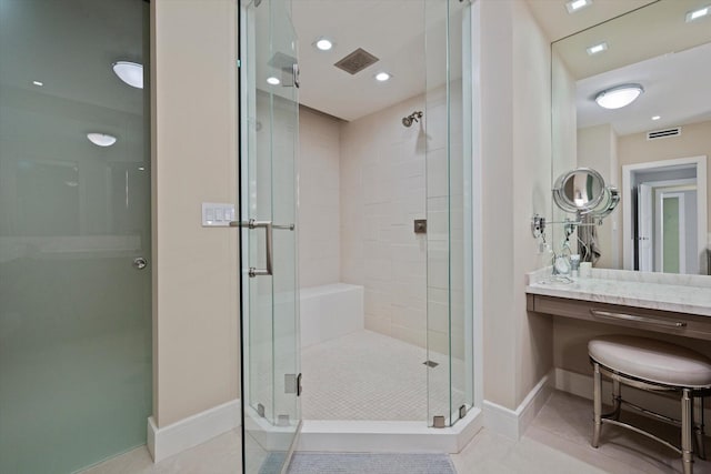 bathroom with tile patterned flooring, vanity, and a shower with shower door