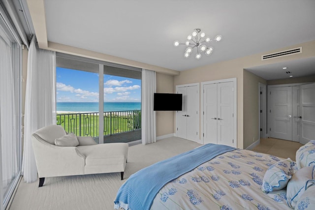 bedroom with a chandelier, visible vents, baseboards, multiple closets, and access to outside