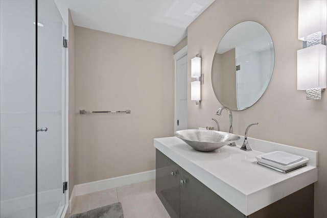 bathroom with a shower stall, vanity, baseboards, and tile patterned floors