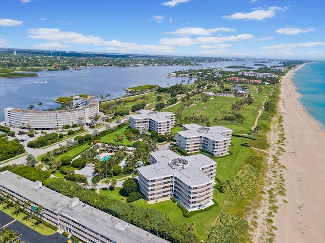 drone / aerial view with a water view and a beach view