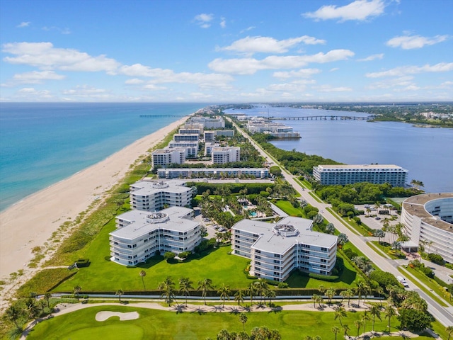 drone / aerial view featuring a beach view and a water view