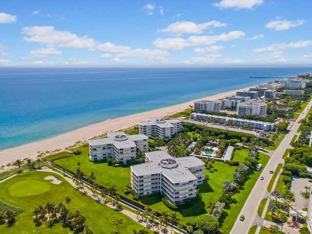 drone / aerial view featuring a view of the beach, a water view, and a view of city