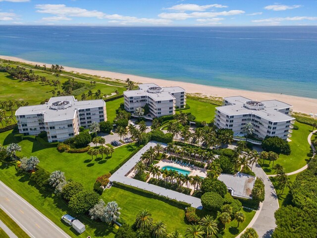 birds eye view of property featuring a water view and a beach view