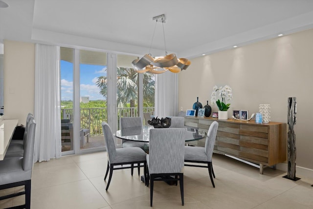 dining area with light tile patterned floors and a notable chandelier