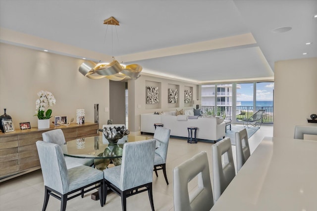 dining room featuring a wall of windows and recessed lighting