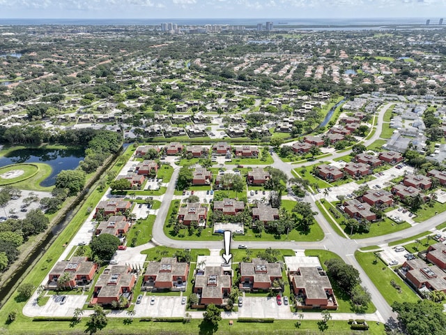 birds eye view of property with a water view and a residential view