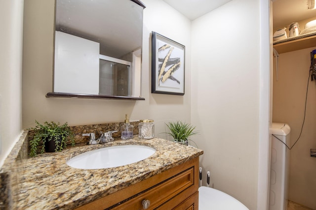 full bathroom featuring toilet, a stall shower, and vanity