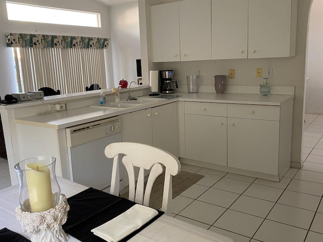 kitchen with white cabinetry, dishwasher, sink, and light tile patterned floors