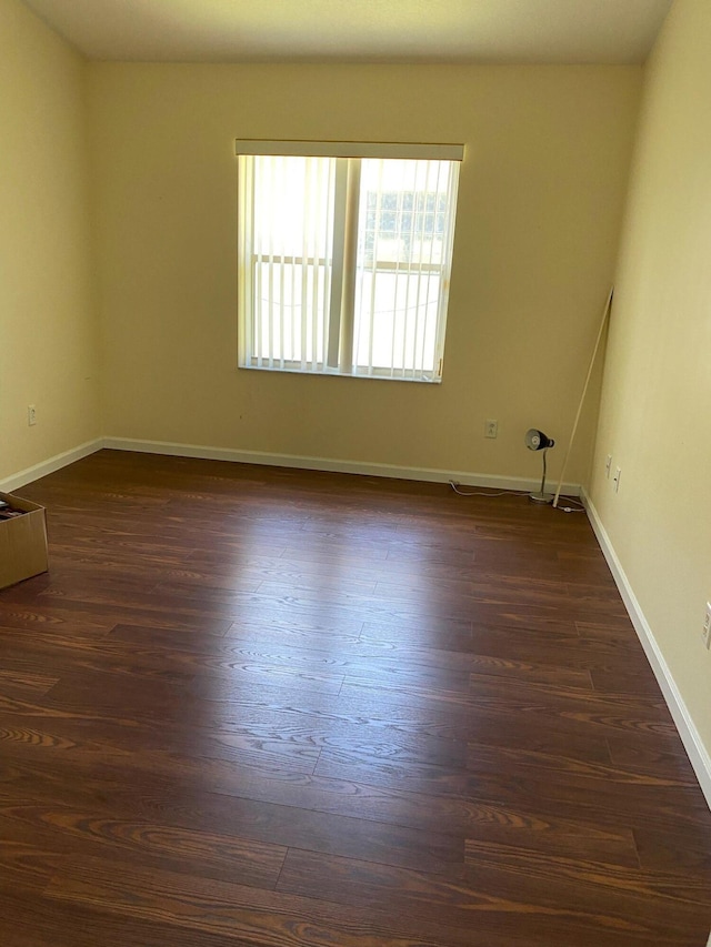 empty room featuring dark hardwood / wood-style flooring