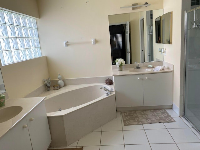 bathroom with vanity, tile patterned flooring, and plus walk in shower