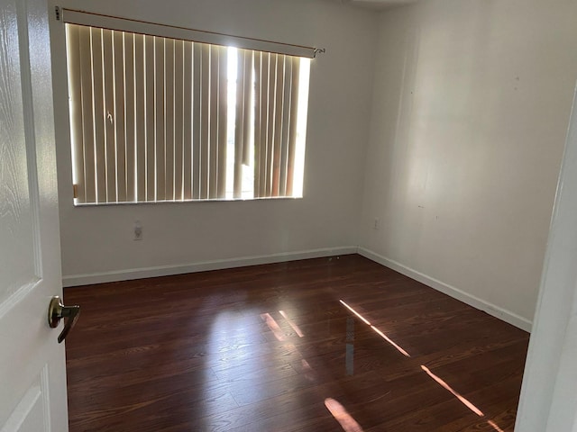 unfurnished room featuring dark wood-type flooring