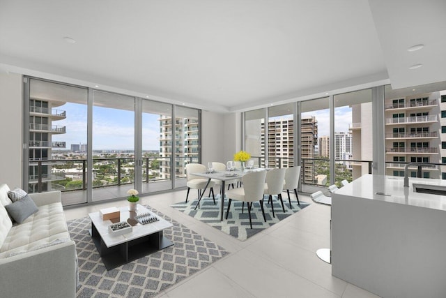 kitchen featuring oven, light countertops, built in microwave, expansive windows, and modern cabinets