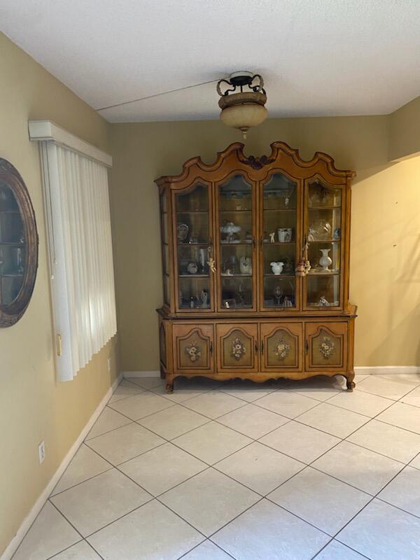 unfurnished dining area featuring light tile patterned flooring