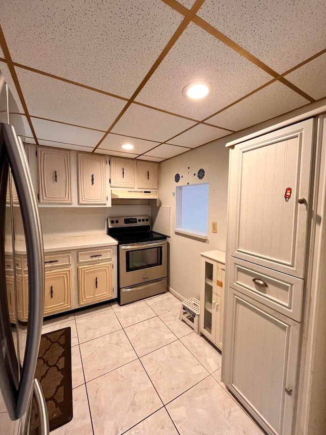 kitchen with appliances with stainless steel finishes, wine cooler, light tile patterned floors, and a drop ceiling