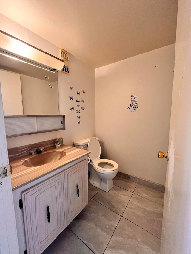 bathroom with tile patterned floors, toilet, and vanity