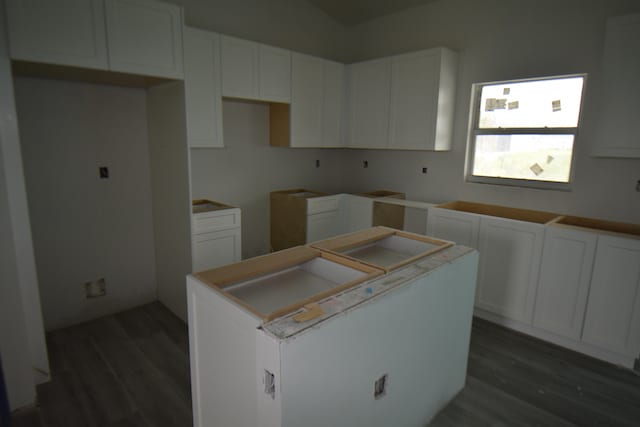 kitchen with white cabinets and dark hardwood / wood-style floors