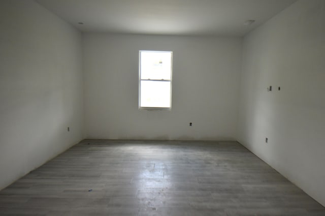 empty room with light hardwood / wood-style flooring