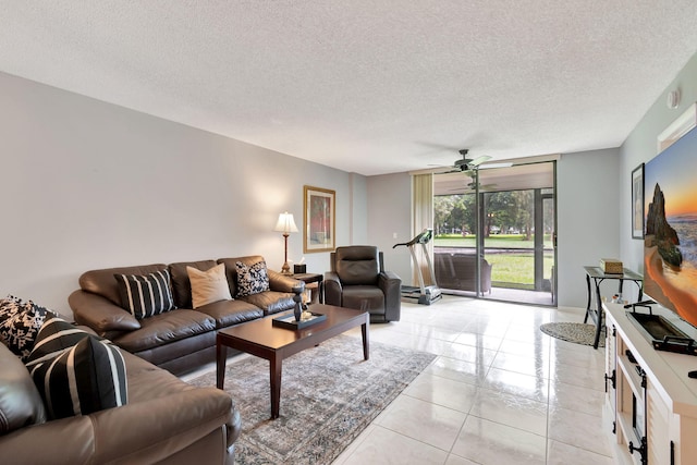 living room featuring a textured ceiling, ceiling fan, and light tile patterned floors