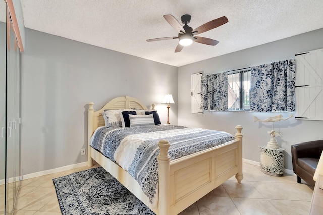 tiled bedroom with a textured ceiling and ceiling fan