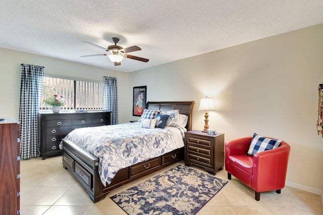 tiled bedroom with ceiling fan and a textured ceiling