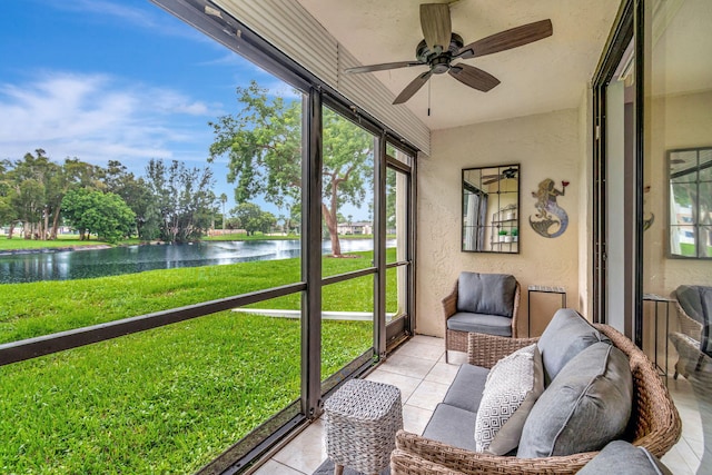 sunroom / solarium with a water view and ceiling fan