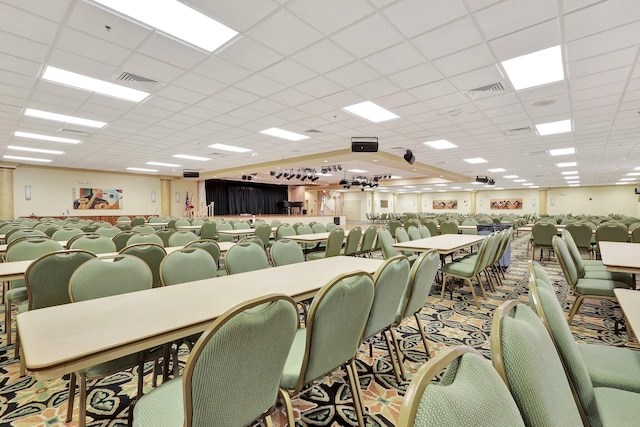 miscellaneous room with a paneled ceiling and carpet