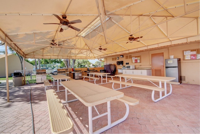 view of patio / terrace with area for grilling and ceiling fan