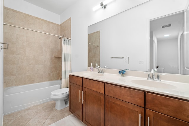 full bathroom featuring vanity, shower / bath combo with shower curtain, toilet, and tile patterned floors