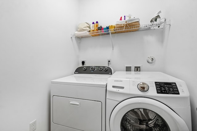 laundry area with washing machine and dryer