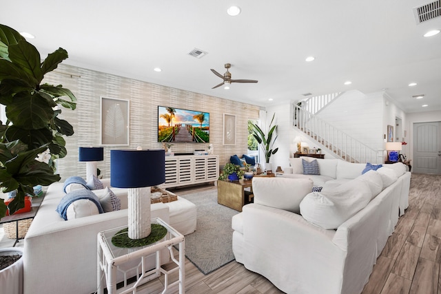 living room featuring ceiling fan and light wood-type flooring