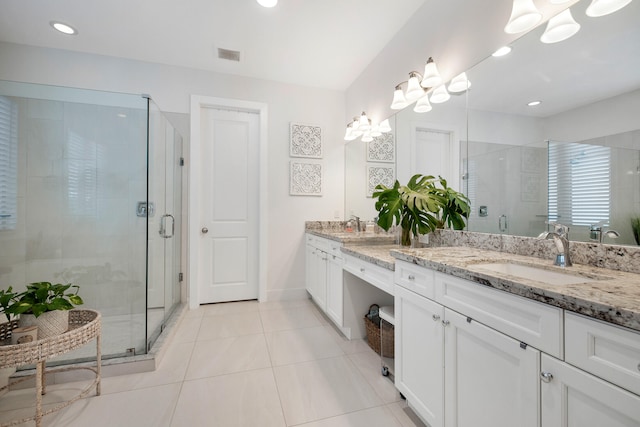 bathroom with tile patterned flooring, vanity, an enclosed shower, and a chandelier