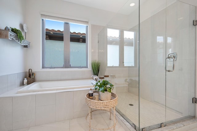 bathroom featuring tile patterned floors and shower with separate bathtub