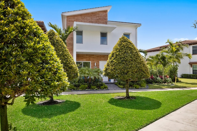 contemporary home with a front yard