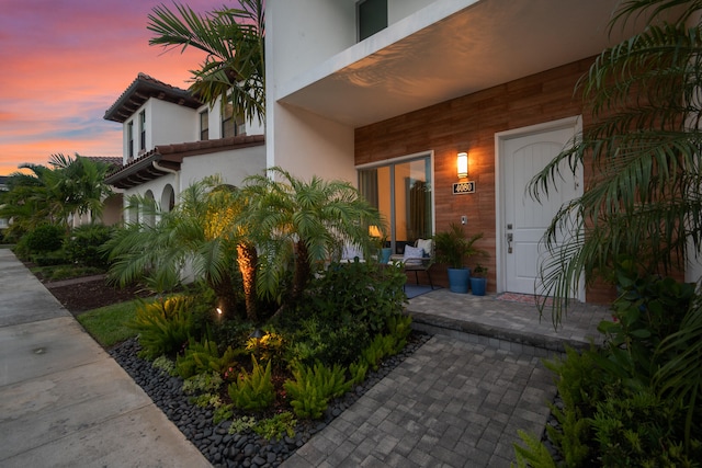 view of exterior entry at dusk