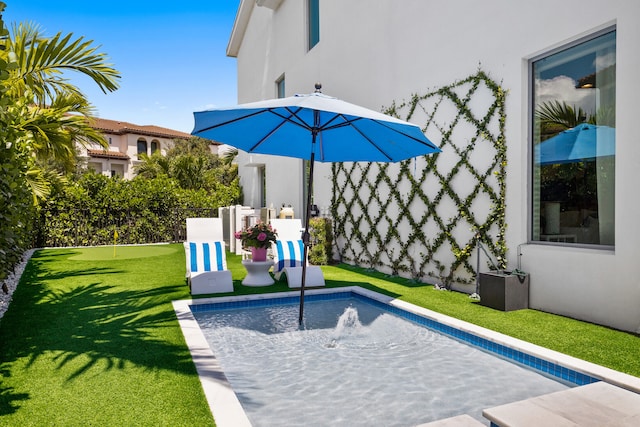 view of pool with a yard and pool water feature