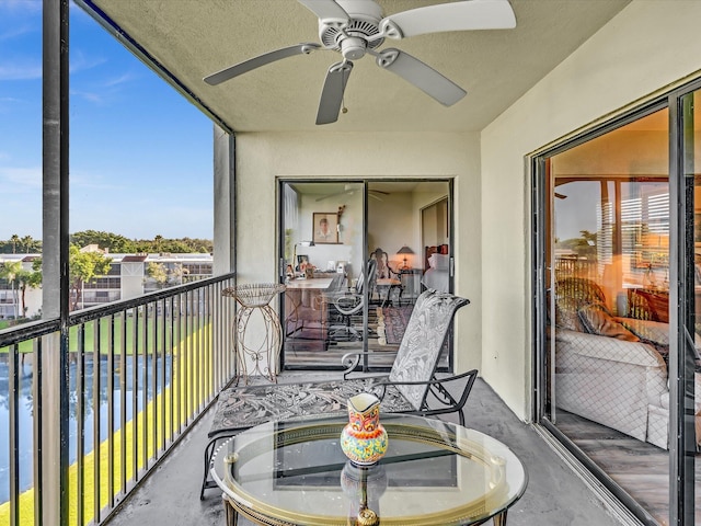 sunroom / solarium featuring a water view