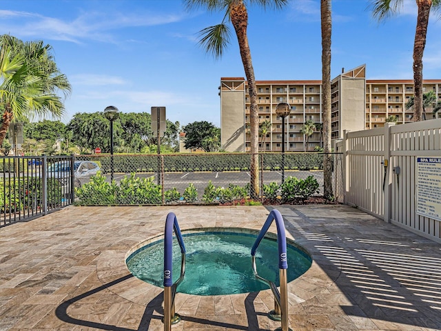 view of swimming pool with a community hot tub