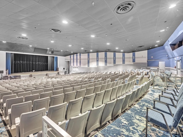 cinema room featuring carpet flooring