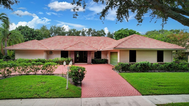 ranch-style home with a front lawn and a garage