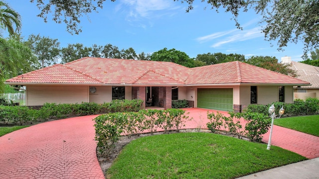 ranch-style home with a garage and a front lawn