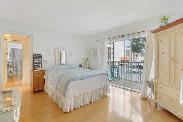 bedroom with access to exterior and light wood-type flooring