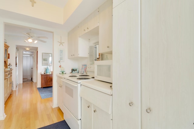 kitchen featuring white cabinets, ceiling fan, white appliances, and light hardwood / wood-style flooring