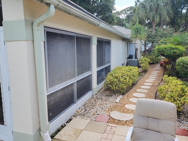 view of side of home with central AC unit