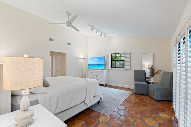 bedroom with ceiling fan, high vaulted ceiling, and track lighting