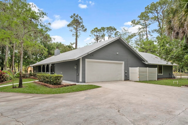 view of side of home featuring a lawn and a garage