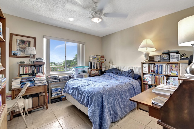 tiled bedroom with a textured ceiling and ceiling fan