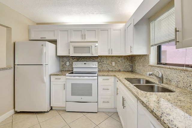 kitchen featuring light tile patterned floors, white appliances, white cabinetry, sink, and a textured ceiling